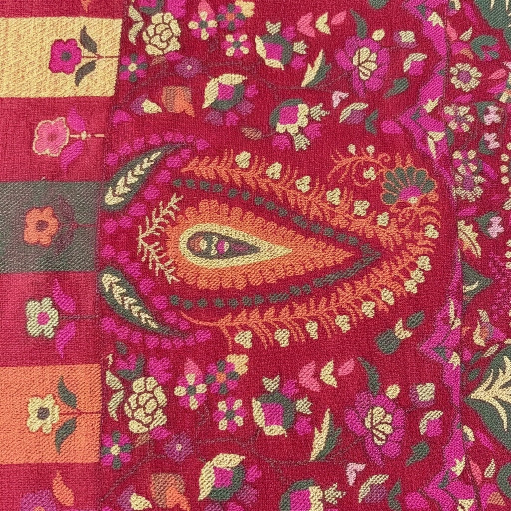 Close-up of a vibrant embroidered fabric with intricate floral pattern